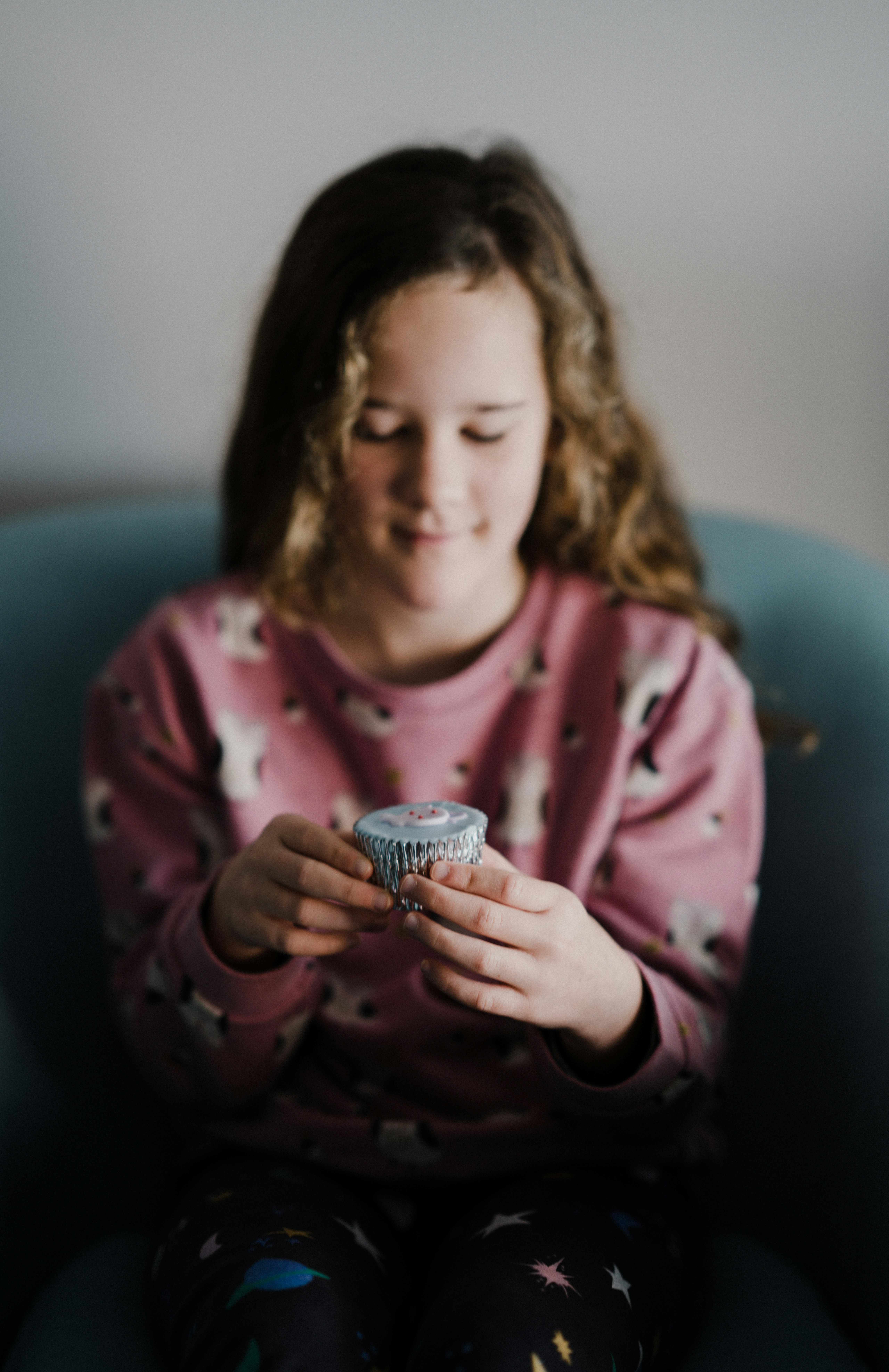 girl holding cupcake